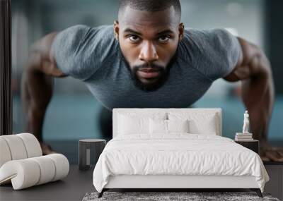 A man is doing a push up on a mat Wall mural