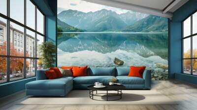 A serene, mountain lake background with clear water and reflection of peaks. Wall mural