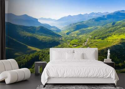 Aerial a mountainous region with winding roads and small villages nestled in the valleys, highlighting the rugged beauty of the terrain Wall mural