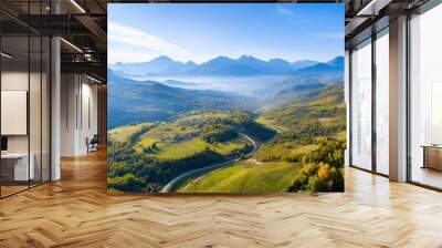 Aerial a mountainous region with winding roads and small villages nestled in the valleys, highlighting the rugged beauty of the terrain Wall mural