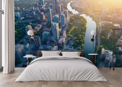 an aerial view of a bustling downtown district during the day, with rows of buildings, green spaces, and a river cutting through the city Wall mural