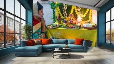 devotee worship to holy hindu god ganesha idol with holy offering at home at ganesh chaturthi Wall mural