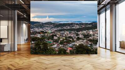 downtown city view with dramatic cloudy sky at evening from mountain top Wall mural