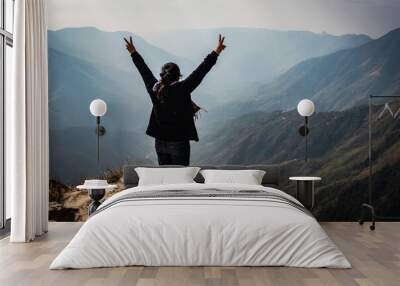 girl watching the beautiful mountain range from edge of mountain Wall mural