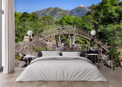 traditional bamboo bridge for crossing mountain river at forest at morning from flat angle Wall mural