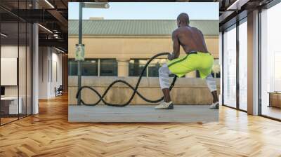 male muscular training with battle ropes Wall mural