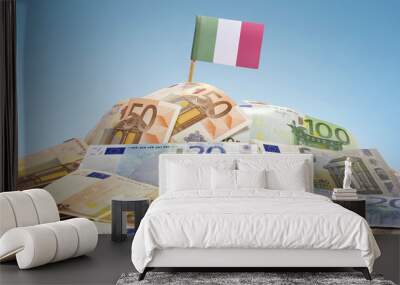 Flag of Italy sticking in a pile of various european banknotes.( Wall mural