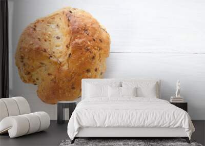 Single cereal bread bun on white wood table Wall mural