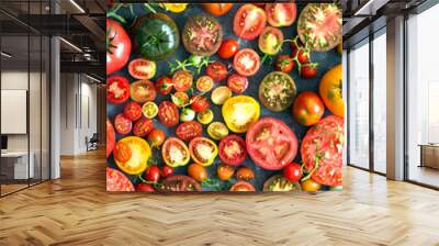 A lot of fresh and ripe tomatoes of different sizes and colours  – top view Wall mural