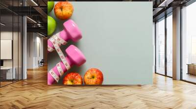 Dieting, healthy and active lifestyles Concept, apples, tape measure  and dumbbells on grey background. top view with blank copy space Wall mural