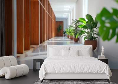 Bright hallway with wooden accents and lush green plants adds a touch of nature to modern architecture. Wall mural