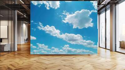 A clear and bright sky with blue skies and white clouds showcasing a beautiful landscape Wall mural