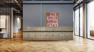 Political protest sign stating Free Speech Under Attack in red letters on a freeway overpass Wall mural