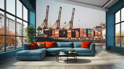 Large cargo ship docked at empty port with stacked containers and idle cranes, symbolizing port strike and industrial tension Wall mural