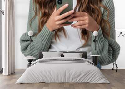 Portrait of young smiling woman using her mobile phone and holding cup of coffee. Isolated transparent background.  Wall mural