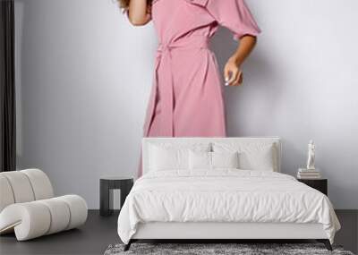 full length portrait of happy beautiful woman in pink dress posing in studio isolated on white backg Wall mural