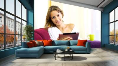 Beautiful woman relaxing with tablet Wall mural