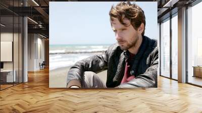 Pensive man in front of the sea thinking feeling sad medium shot Wall mural