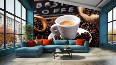 Expresso coffee cup close-up over dark roasted coffee beans Wall mural