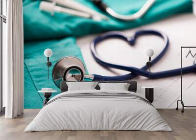 Medical stethoscope twisted in heart shape. Wall mural