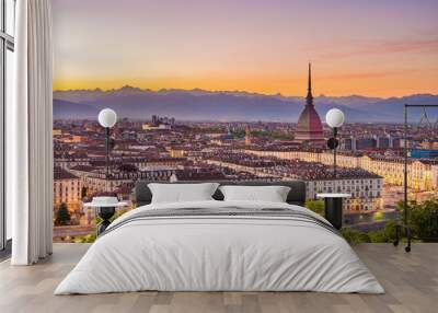 Cityscape of Torino (Turin, Italy) at dusk with colorful moody sky. The Mole Antonelliana towering on the illuminated city below. Wall mural