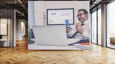 Business man working with laptop sitting at the desk. Male works at computer communicate online with remote office. Health care quarantine lifestyle, home working, homeschooling new technology concept Wall mural