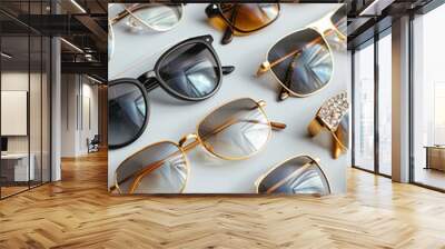 Trendy sunglasses of different design and eyeglasses on gray background with golden palm leaf. Copy space. Sunglasses and spectacles sale concept. Optic shop promotion banner. Eyewear fashion Wall mural