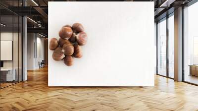 Raw whole brown chestnuts heap Wall mural