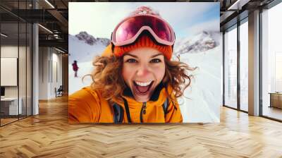 Winter sport smiling young woman selfie portrait against snowy mountains landscape Wall mural