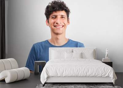 Portrait of a young man smiling with strabismus Wall mural