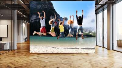 Group of friends of different nationalities on vacation on a mountain lake in the middle of nature, take pictures and celebrate spring or summer Wall mural