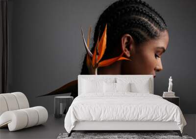 African American young woman with paradise flower posing indoor. Mock-up. Wall mural