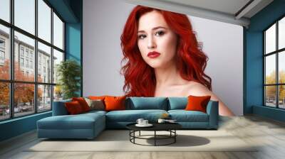 Headshot of sensual woman with beautiful long red hair posing over white background. Space for text. Wall mural