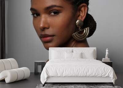 Portrait of African young woman with braids hairstyle posing on grey wall. Wall mural