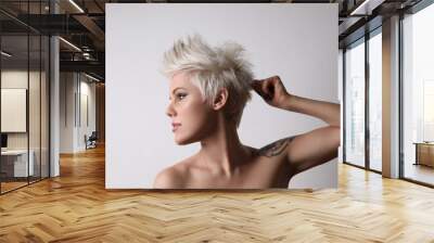 Portrait of beautiful blond young woman with short hair. Studio shot. Wall mural