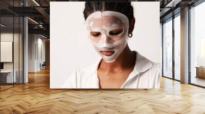 Young woman applies a hydro gel face mask. Skin care and beauty treatments Wall mural