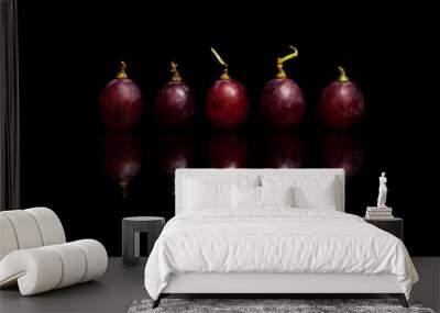 Five red grapes isolated on black background Wall mural