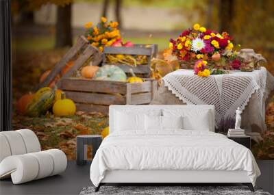 Autumn decor in the garden in rustic style. Pumpkins lying in wooden box on autumn background.  Old fashioned wooden distaff. Autumn time. Thanksgiving Day. Wall mural