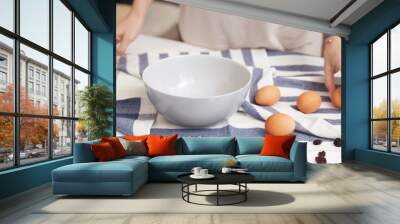 Blue bowl, natural eggs and woman hands. Ready to start cooking Wall mural