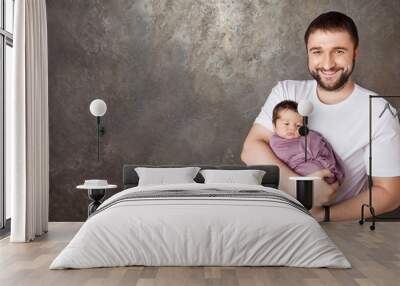 Smiling father holding his newborn baby  in  hands.Happy family concept. Copy space Wall mural