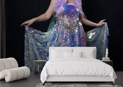 Full length portrait of beautiful female model with long purple hair wearing elf ears, a fantasy fairy crown and  rainbow glitter sequin ball gown. graceful standing pose,  isolated in dark studio bac Wall mural