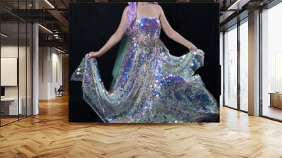 Full length portrait of beautiful female model with long purple hair wearing elf ears, a fantasy fairy crown and  rainbow glitter sequin ball gown. graceful standing pose,  isolated in dark studio bac Wall mural