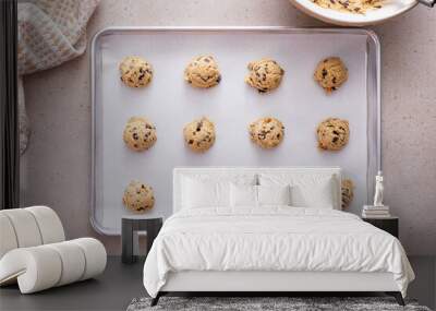 Chocolate chip cookie dough scoopes on a cookie sheet ready to be baked Wall mural