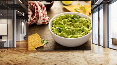 Chunky homemade guacamole in a bowl with tortilla chips Wall mural