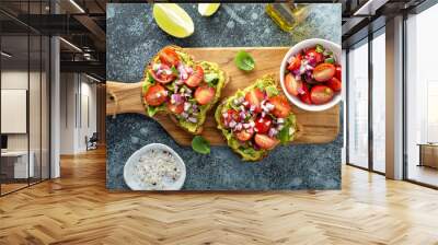 Fresh avocado toast with tomatoes, onions and herbs overhead shot Wall mural