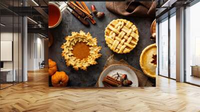 Homemade pumpkin pies decorated with fall leaves Wall mural