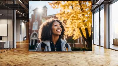 Portrait of a smiling young black female student on colledge campus in the fall, ready to start school year, generative AI Wall mural