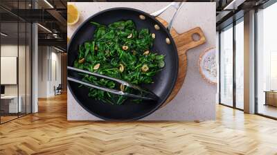 Sauteed spinach with garlic in a skillet Wall mural