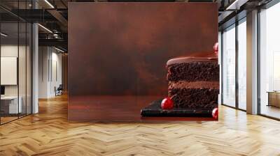 Slice of rich chocolate cake with creamy frosting, set on a rustic wooden background Wall mural