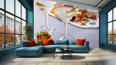 Traditional martini cocktail with olive garnish and charcuterie board Wall mural